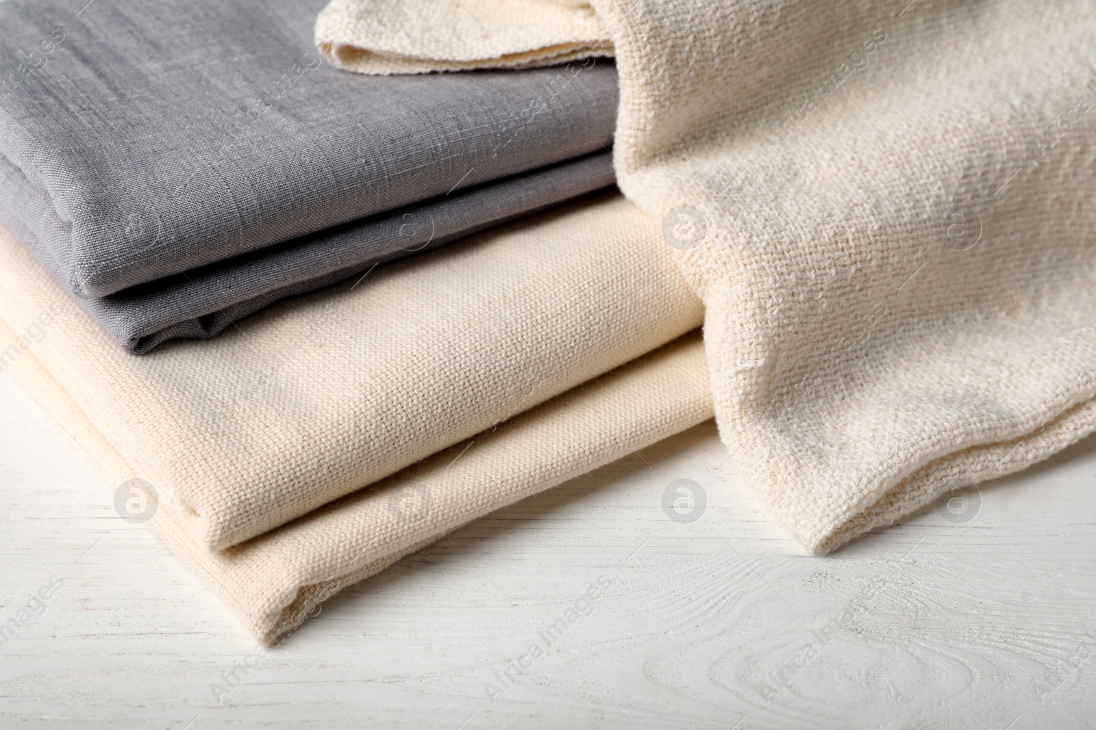 Photo of Hemp cloths on white wooden table, closeup