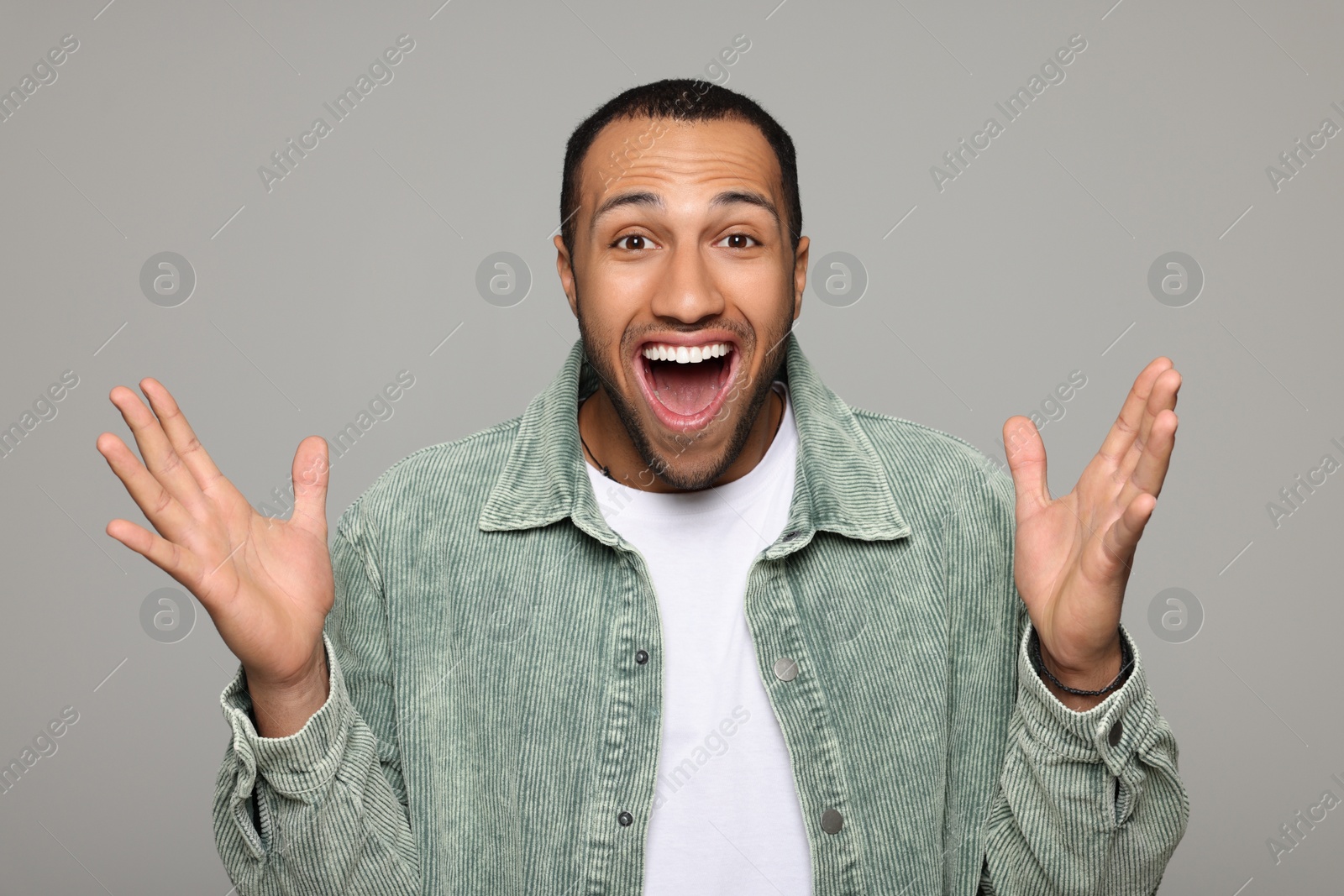 Photo of Portrait of happy African American man on light grey background