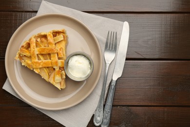 Photo of Piece of tasty homemade quince pie served on wooden table, flat lay. Space for text