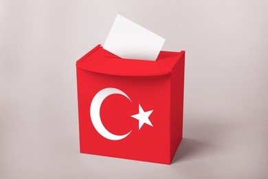 Image of Ballot box decorated with flag of Turkey on light background