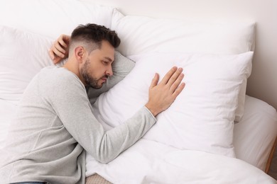 Upset man lying on bed. Loneliness concept