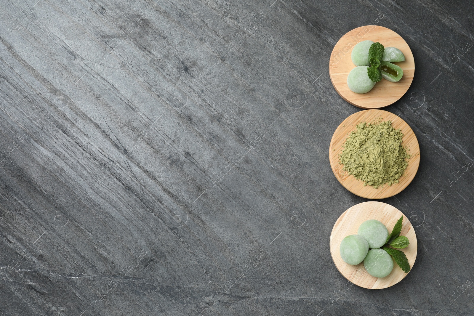 Photo of Delicious matcha mochi on grey table, flat lay. Space for text
