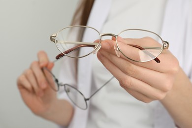 Photo of Woman with glasses on light background, closeup