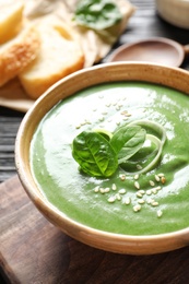 Photo of Fresh vegetable detox soup made of spinach in dish on table, closeup