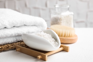 Sea salt for spa scrubbing procedure in bowl on white table