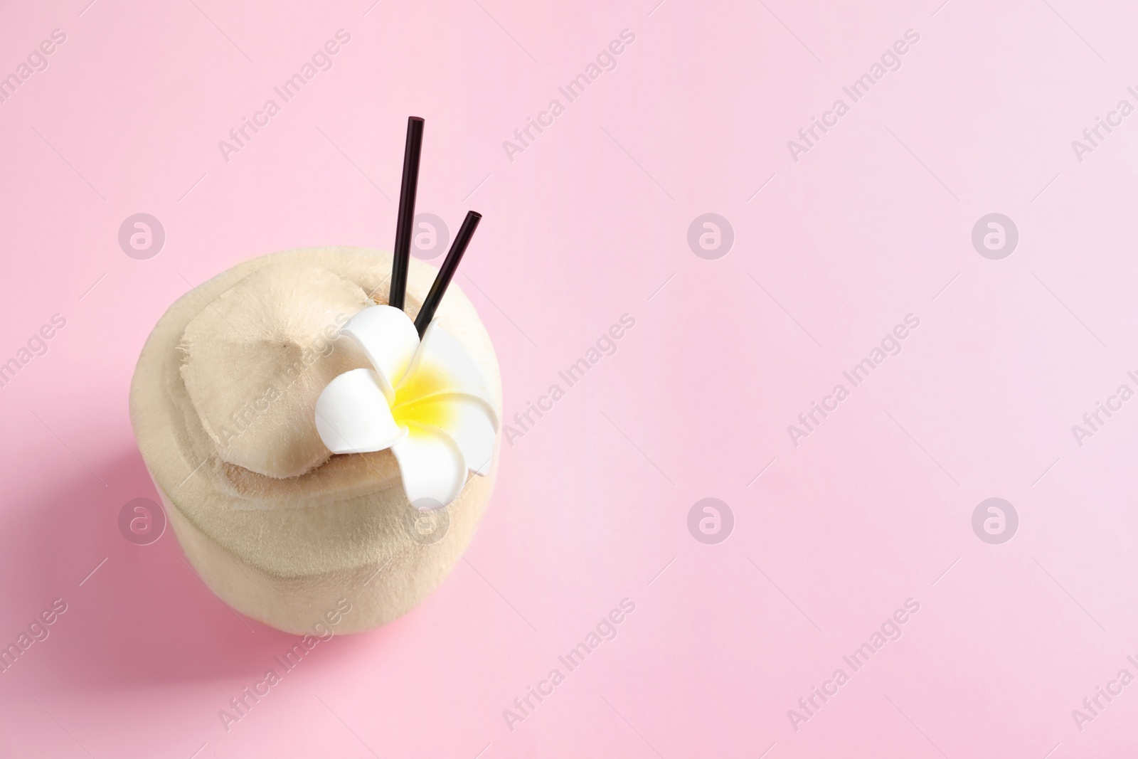 Photo of Fresh coconut drink in nut on color background