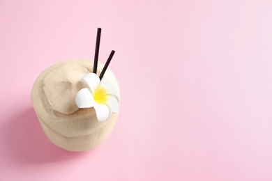 Photo of Fresh coconut drink in nut on color background