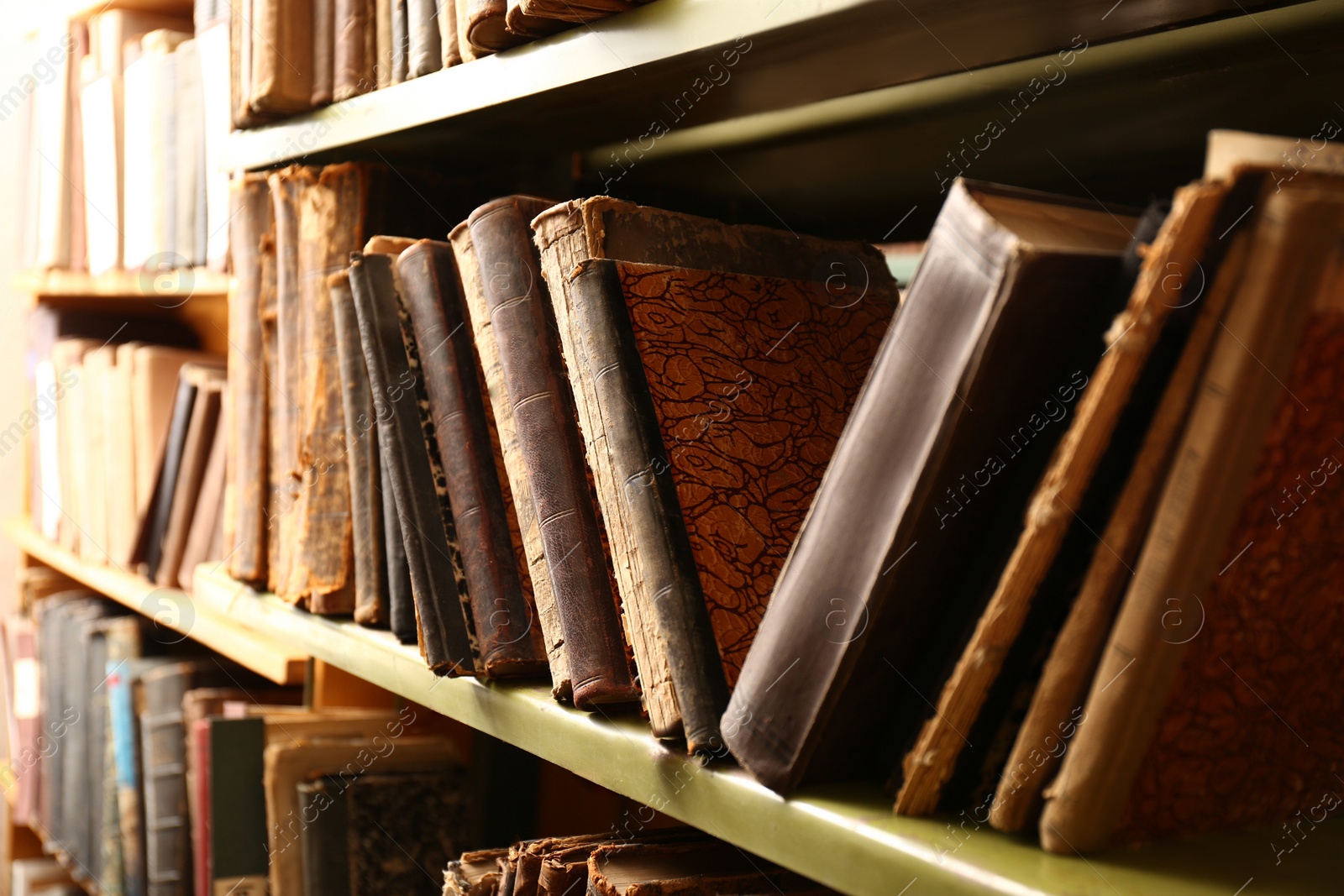 Photo of Collection of old books on shelves in library