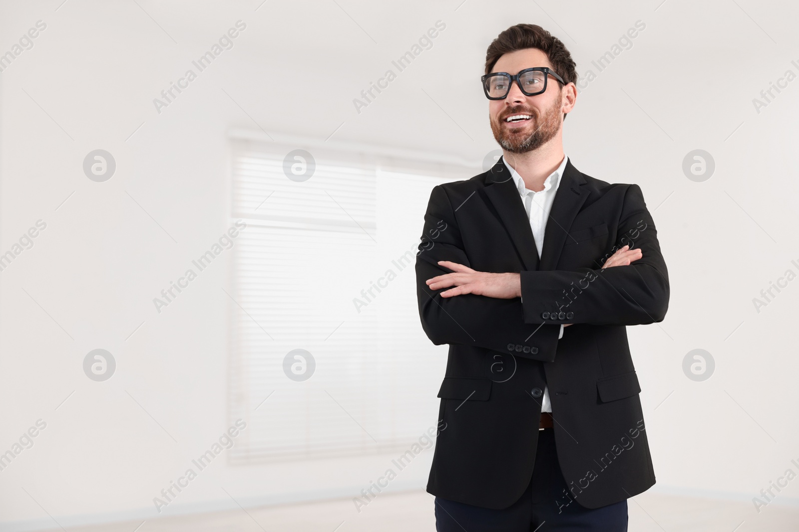 Photo of Happy real estate agent in new apartment. Space for text