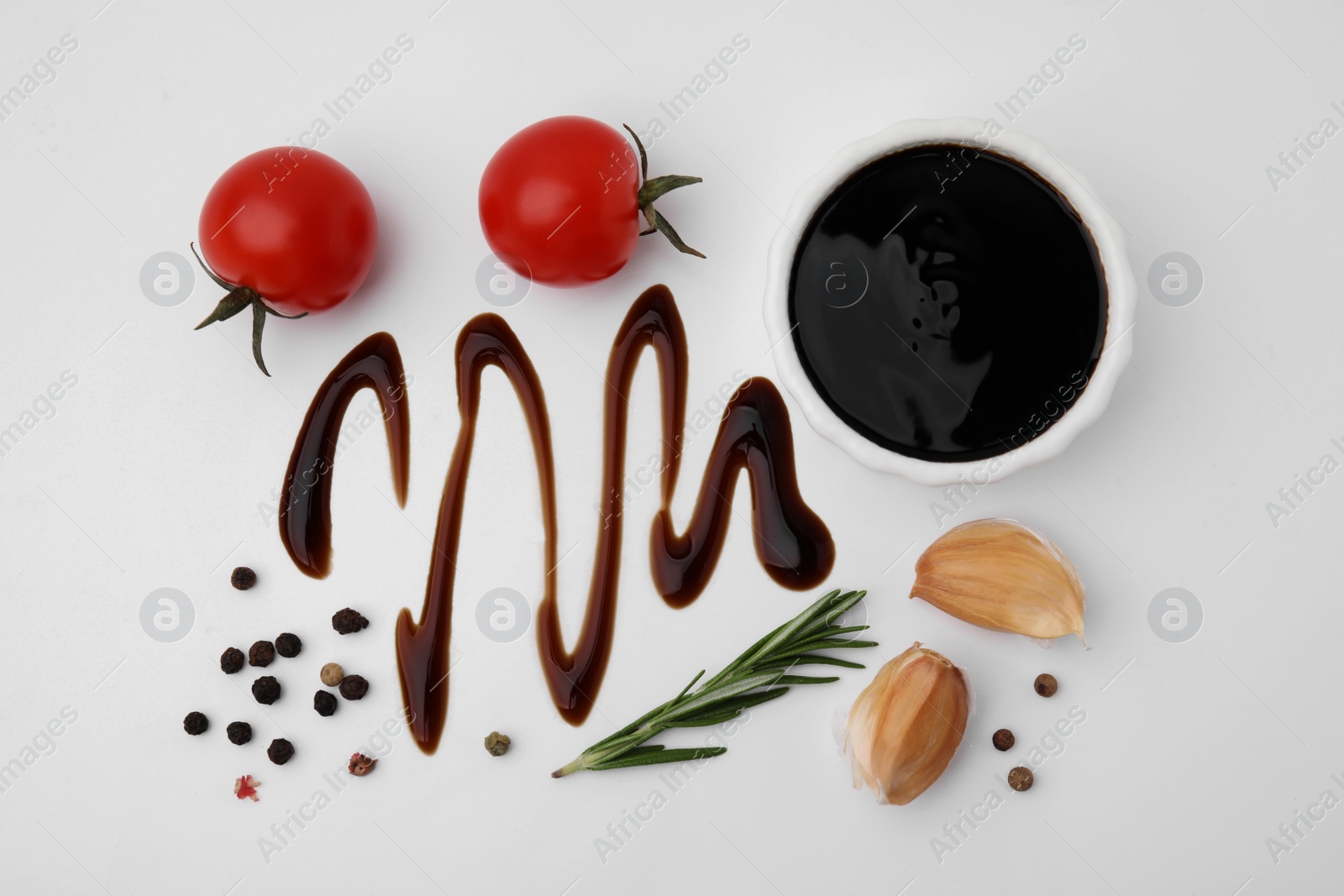 Photo of Organic balsamic vinegar and cooking ingredients on white background, flat lay