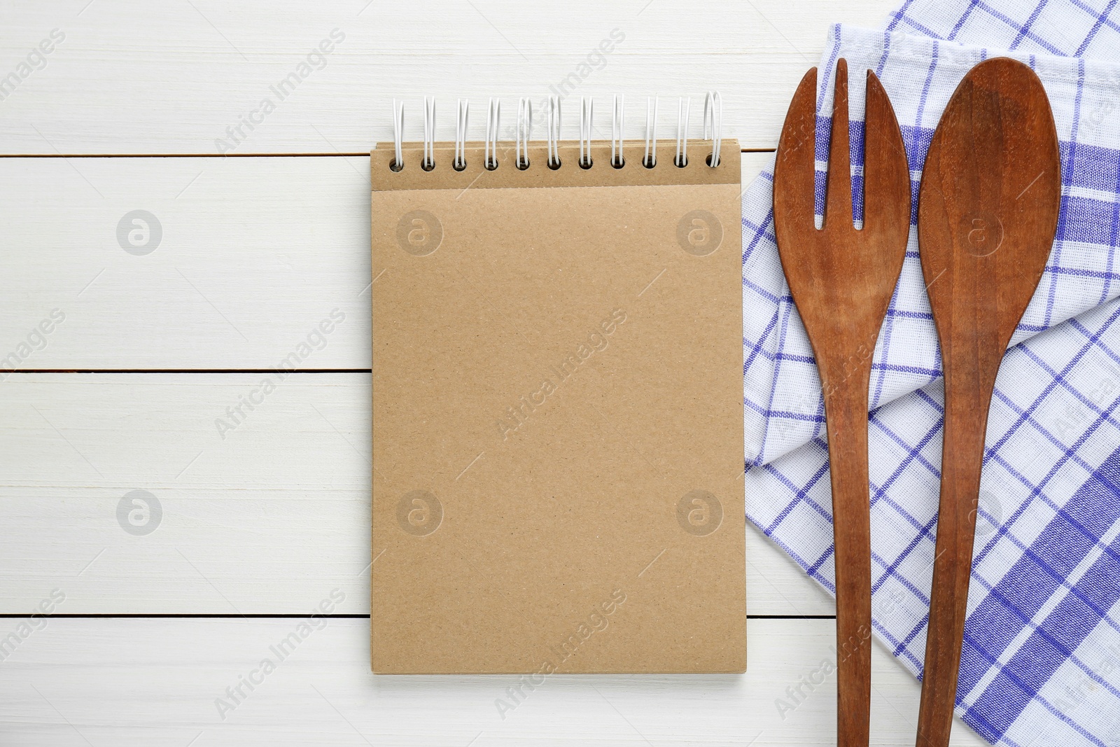 Photo of Blank recipe book and kitchen utensils on white wooden table, flat lay. Space for text