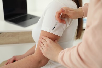 Diabetes. Woman getting insulin injection indoors, closeup