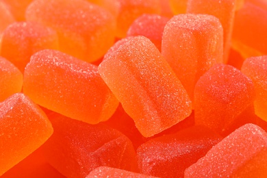 Photo of Tasty orange jelly candies as background, closeup