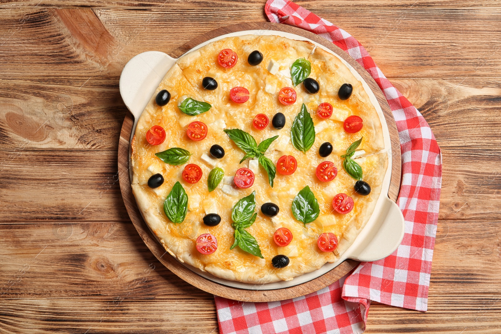 Photo of Fresh tasty homemade pizza on wooden background, top view