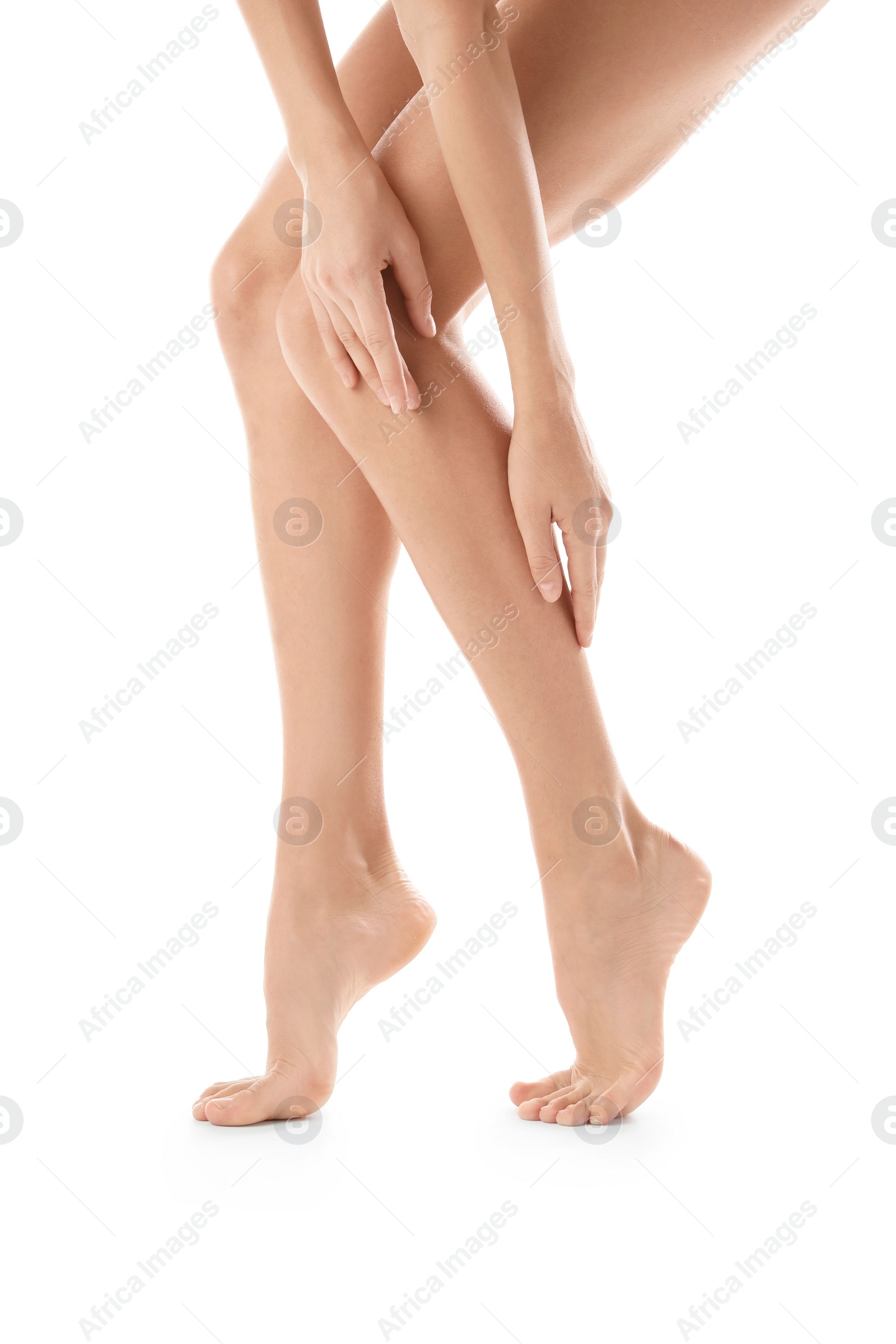 Photo of Young woman with beautiful long legs on white background, closeup