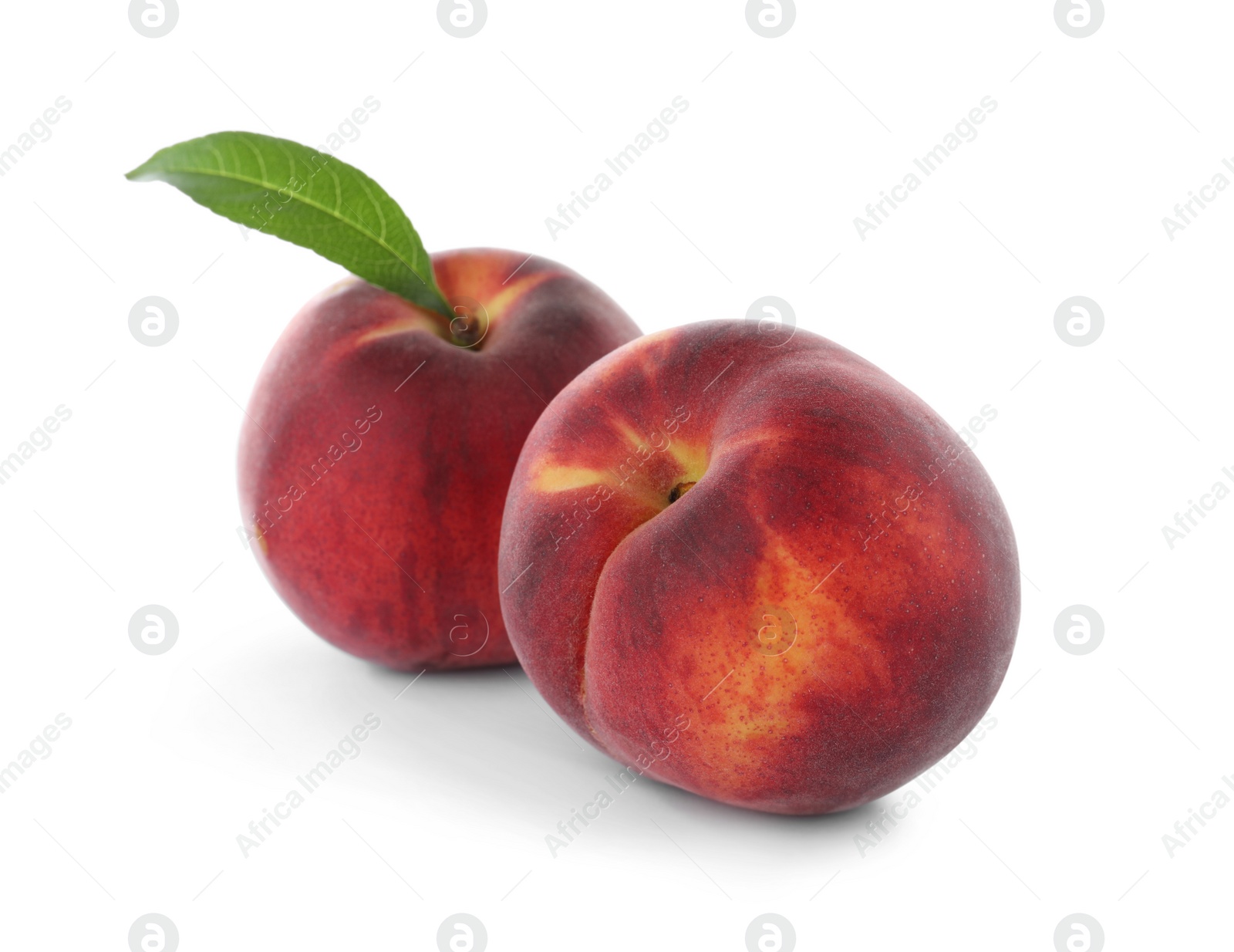 Photo of Delicious ripe peaches with leaf isolated on white