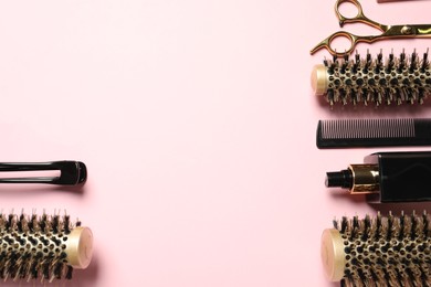 Photo of Professional hair dresser tools on pink background, flat lay. Space for text