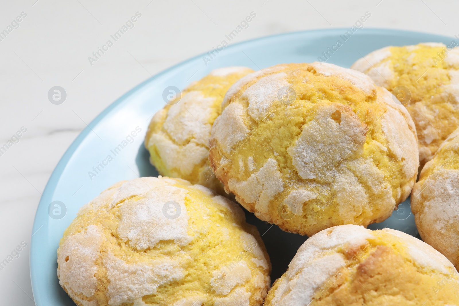 Photo of Plate with delicious lemon cookies on white table, closeup