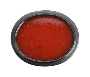 Photo of Spicy chili sauce in bowl isolated on white, top view