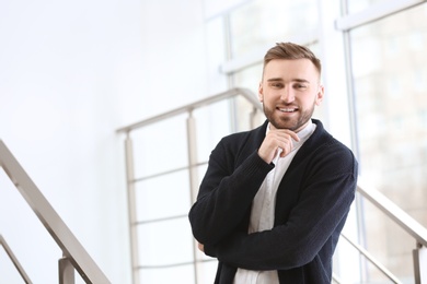 Photo of Portrait of confident young man on stairs