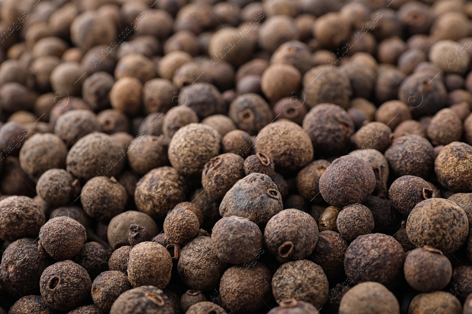 Photo of Black pepper grains as background, closeup view