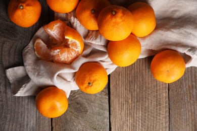 Photo of Tasty fresh tangerines on wooden table, flat lay