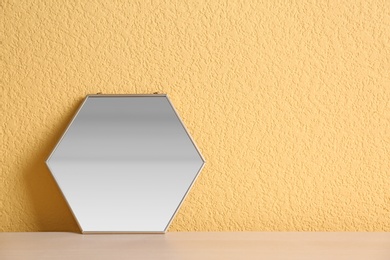 Photo of Mirror on table near color wall