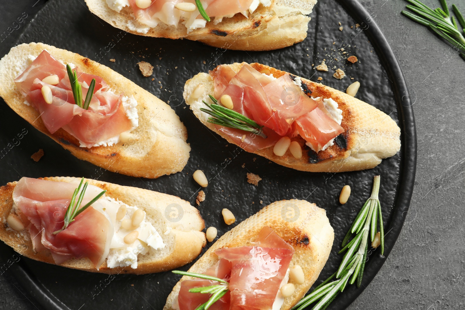 Photo of Flat lay composition with tasty bruschettas on grey table