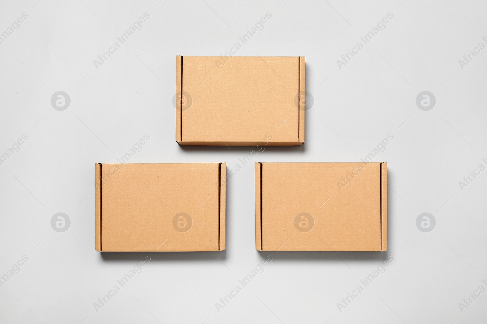 Photo of Cardboard boxes on white background, flat lay. Packaging goods