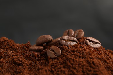 Pile of ground coffee with roasted beans, closeup