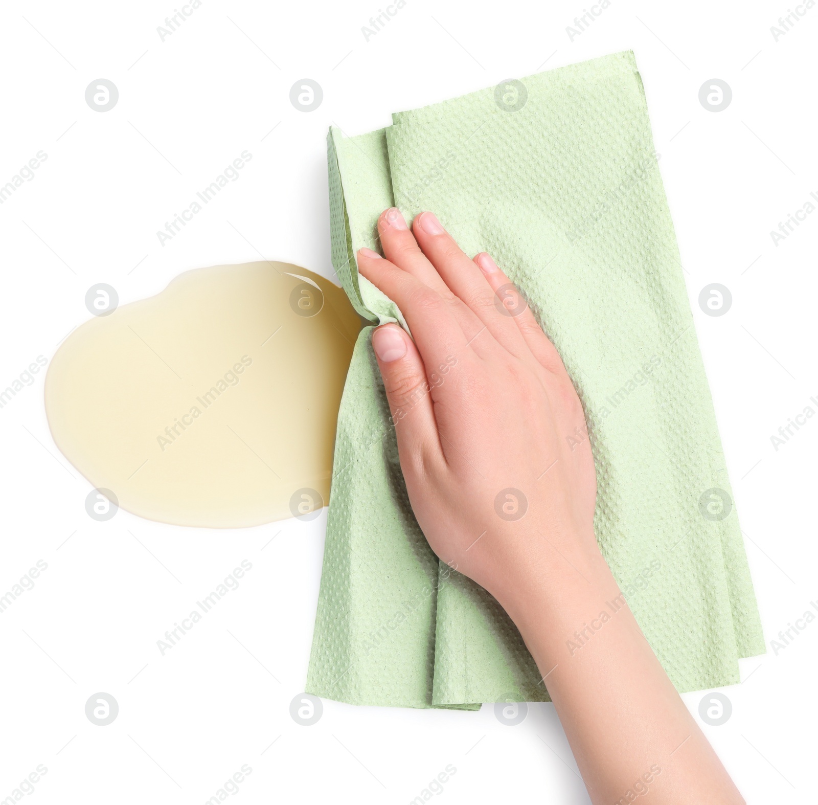 Photo of Woman wiping spilled oil on white background, top view