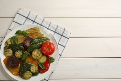 Delicious grilled vegetables on white wooden table, top view. Space for text
