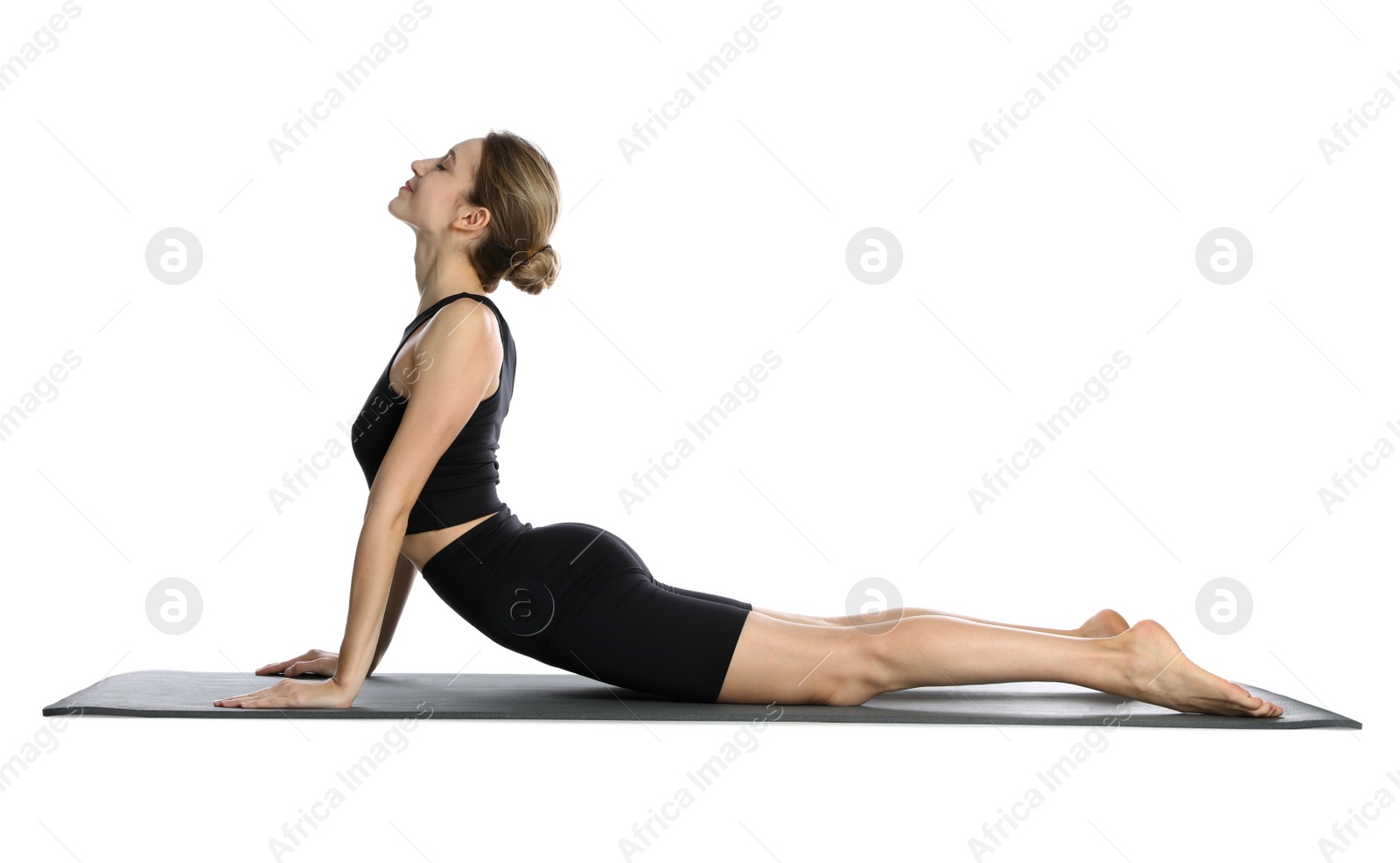 Photo of Young woman in sportswear practicing yoga on white background