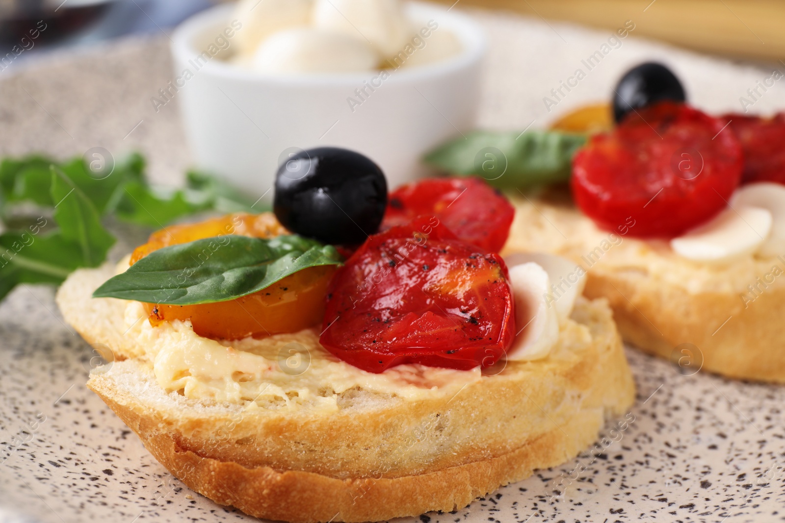 Photo of Delicious tomato bruschettas on ceramic plate, closeup