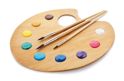 Photo of Palette with paints and brushes on white background