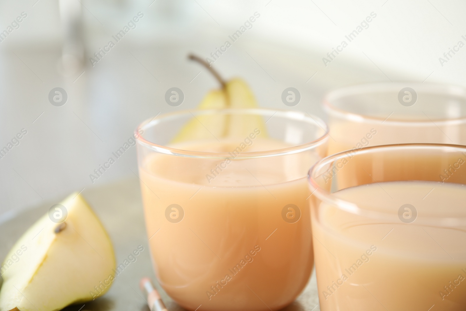 Photo of Glasses of tasty fresh pear juice, closeup