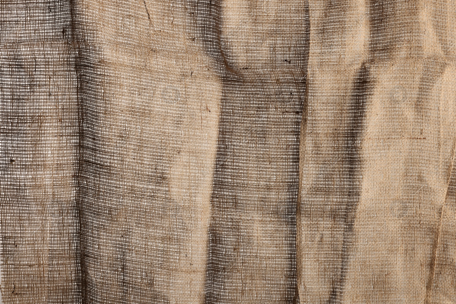 Photo of Texture of natural burlap fabric as background, closeup