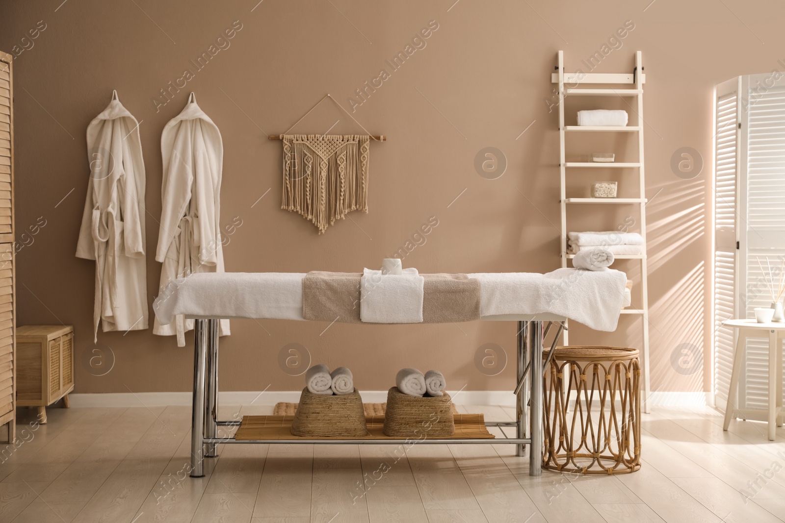 Photo of Stylish spa salon interior with massage table