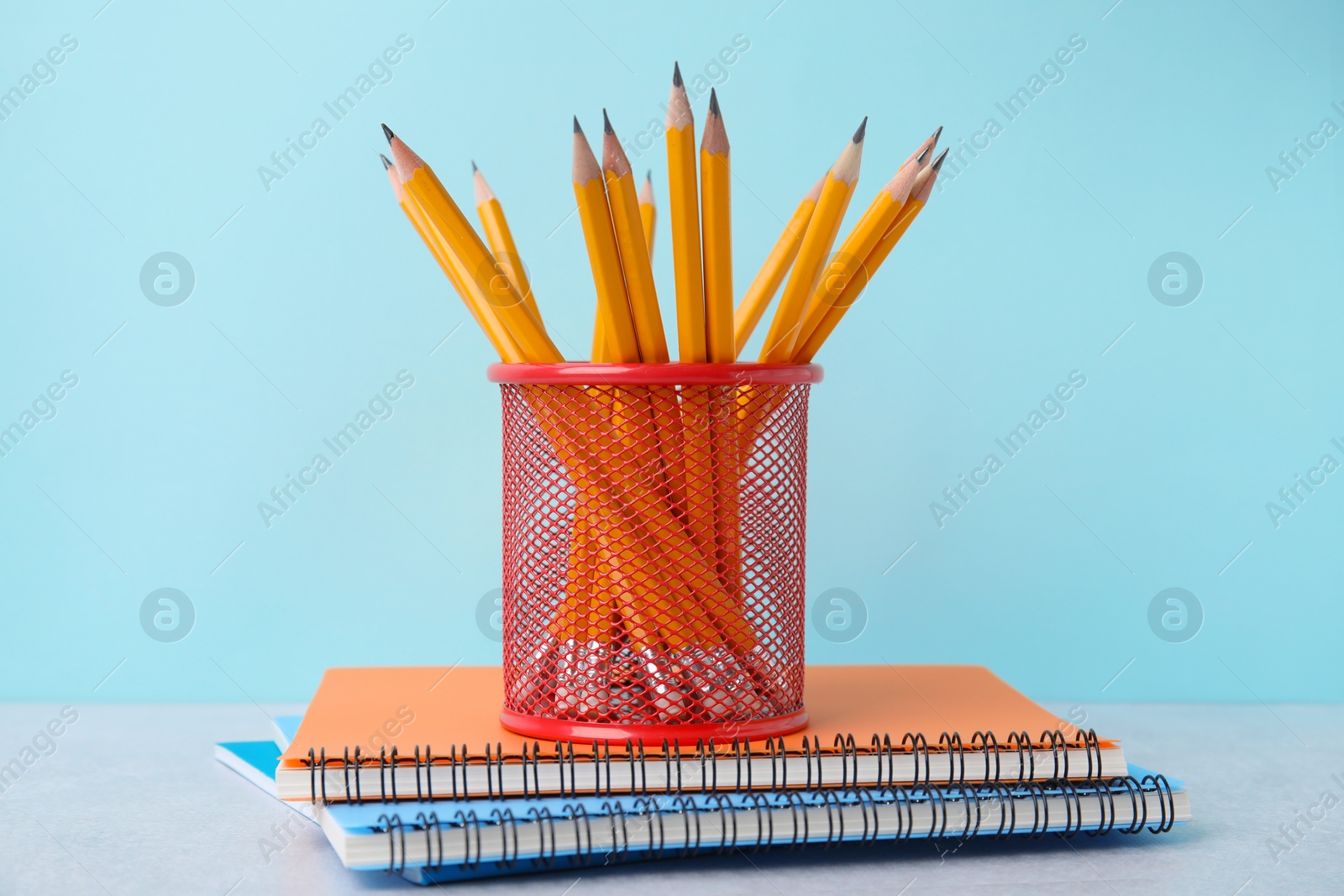 Photo of Different school stationery on table against light blue background. Back to school
