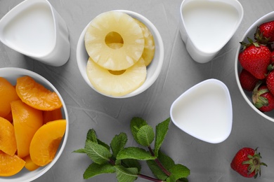 Photo of Flat lay composition with ingredients for yogurt on grey background. Multi cooker recipe