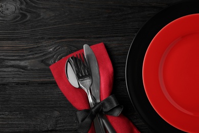 Photo of Beautiful table setting on black wooden background, flat lay