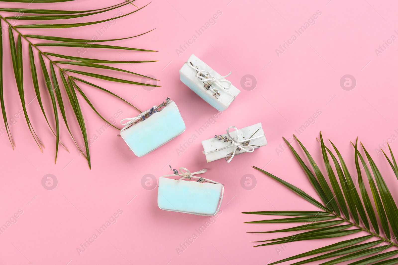 Photo of Flat lay composition with natural handmade soap on pink background