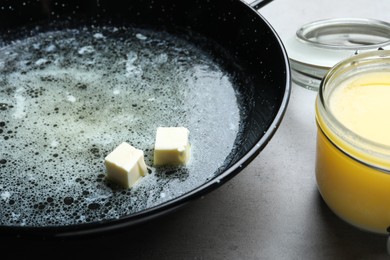 Photo of Melting butter in frying pan, closeup view