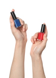 Woman holding nail polishes on white background, closeup