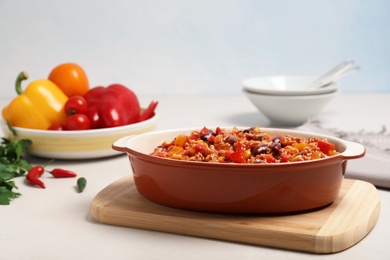 Baking dish with chili con carne on table