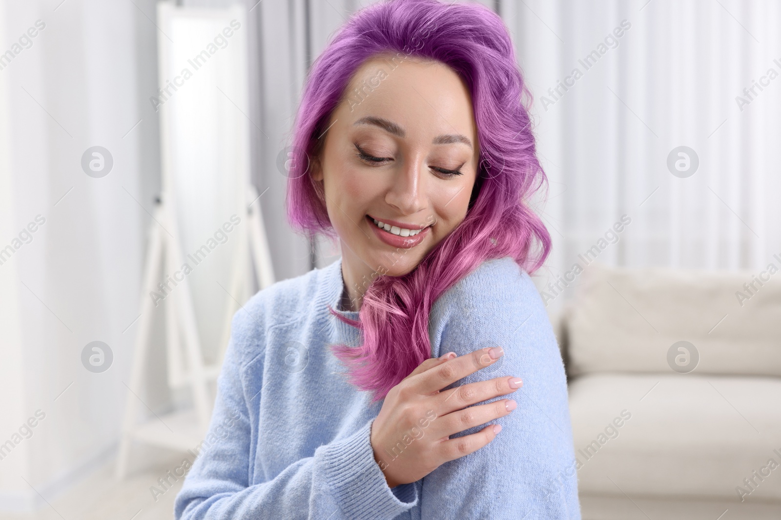 Image of Trendy hairstyle. Young woman with colorful dyed hair at home