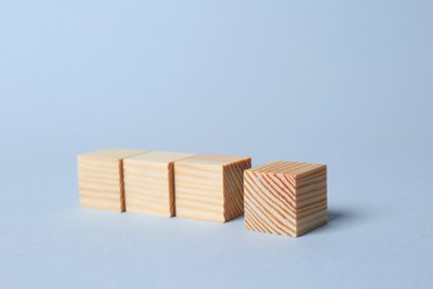 Photo of Wooden cubes on light background. Idea concept
