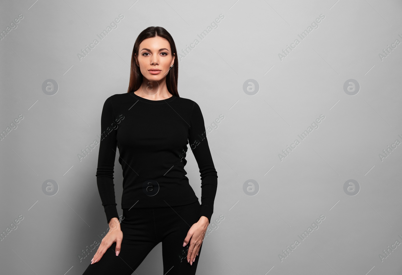 Photo of Woman wearing thermal underwear on grey background. Space for text