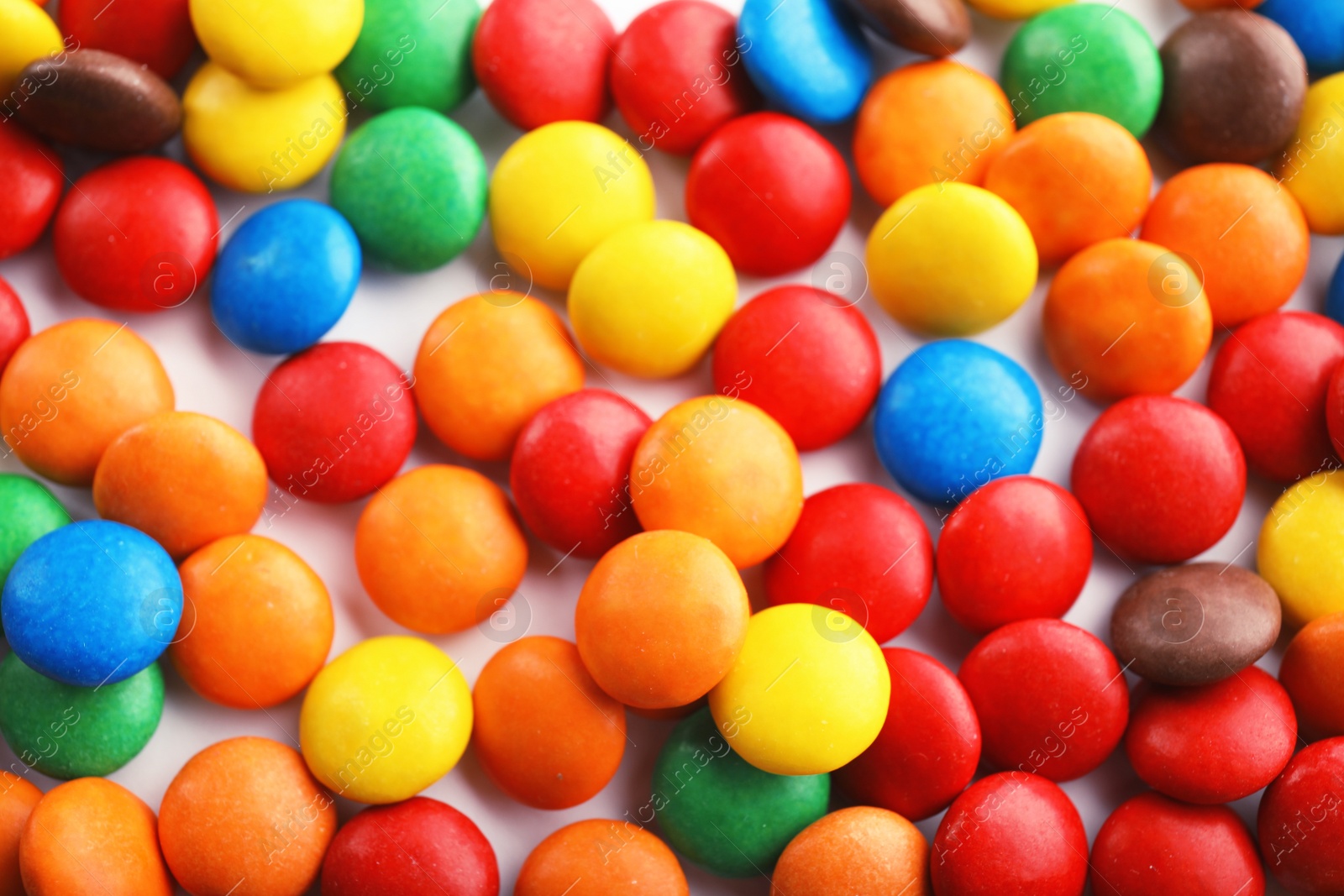 Photo of Many colorful candies as background, top view