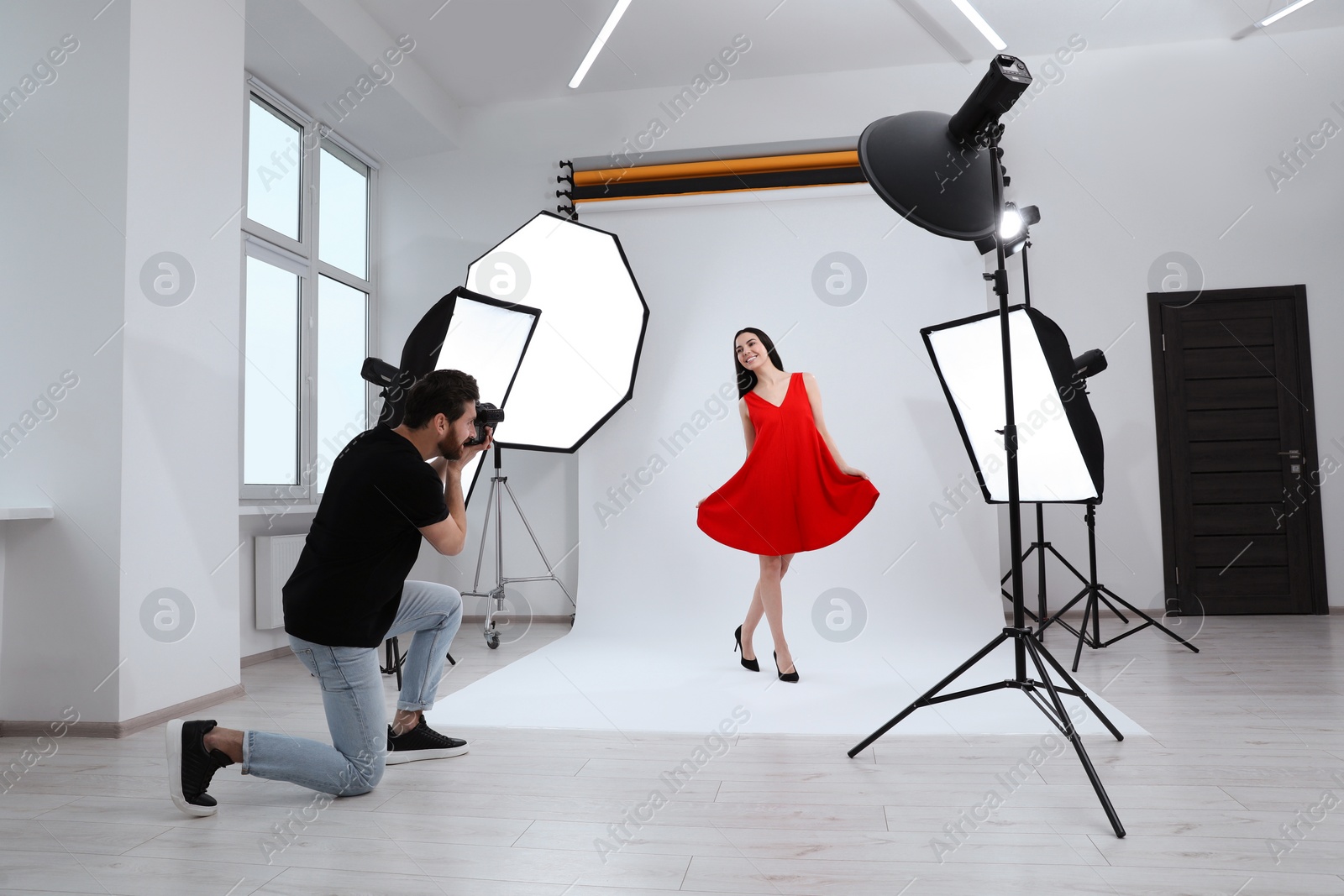 Photo of Beautiful young model posing for professional photographer in studio